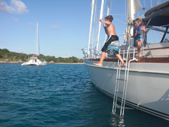 Young children jump off La Boheme to swim